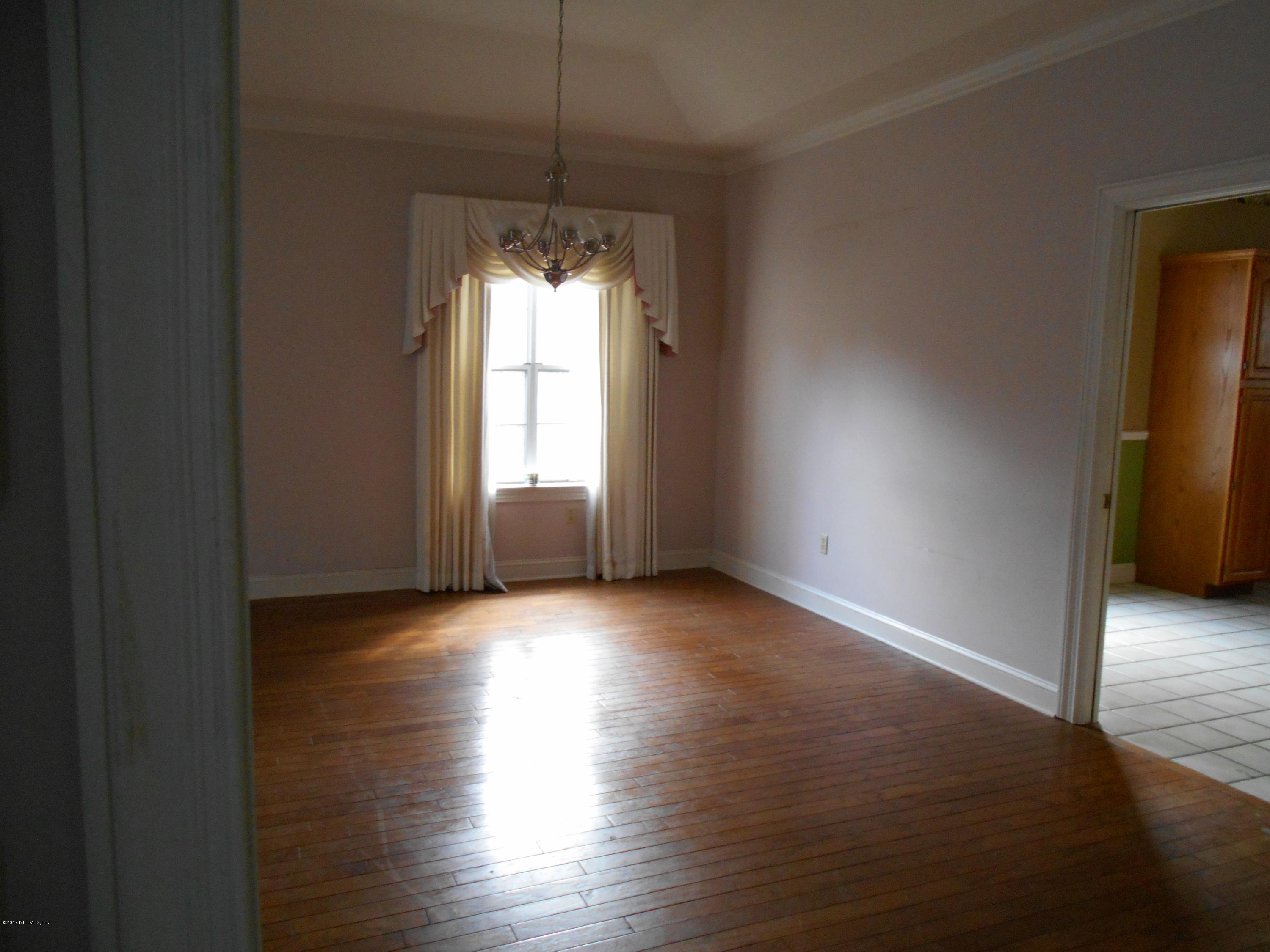 3006 Holly Road Orange Park, FL 32065 - Photo 8 of 19 an empty room with wooden floor and windows