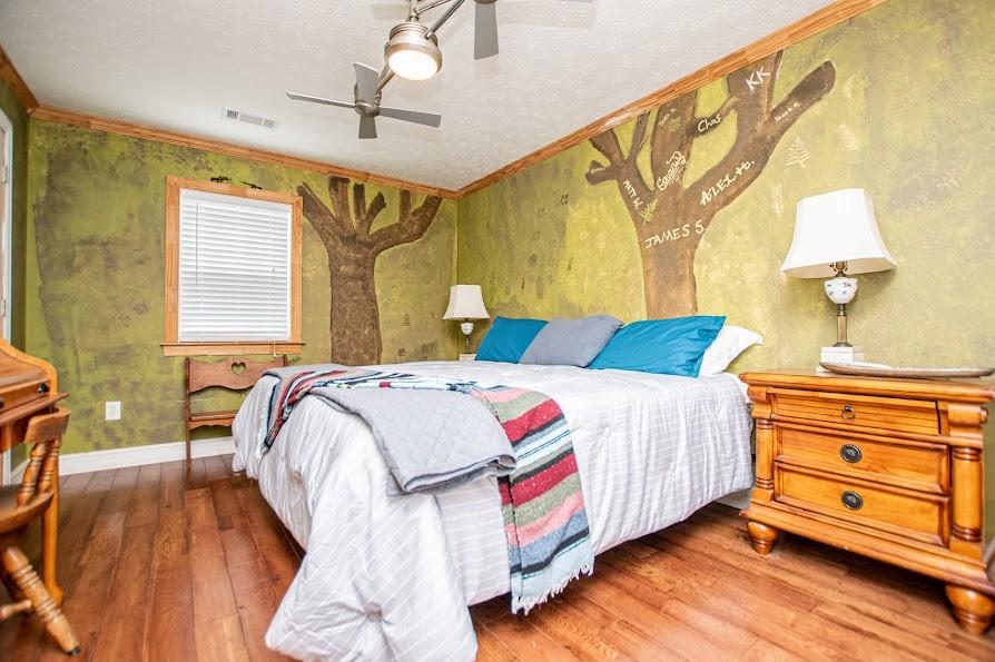 575 Liberty Church Road Carrollton, GA 30116 - Photo 46 of 95 a bedroom with a bed and wooden floor