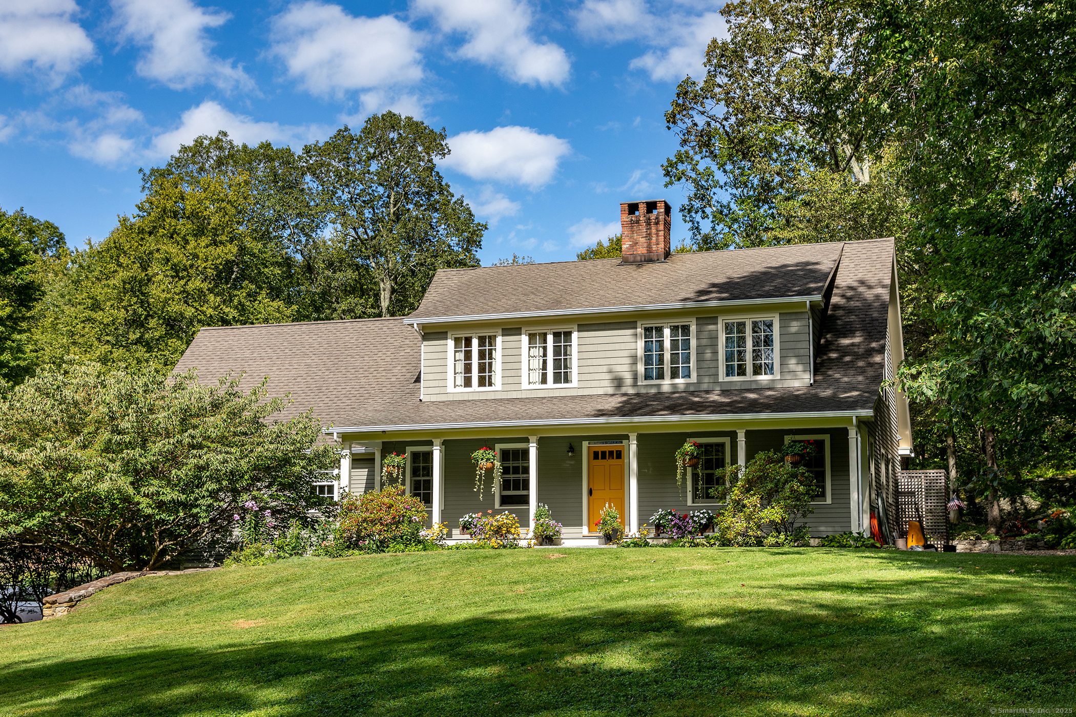 a front view of a building with a garden