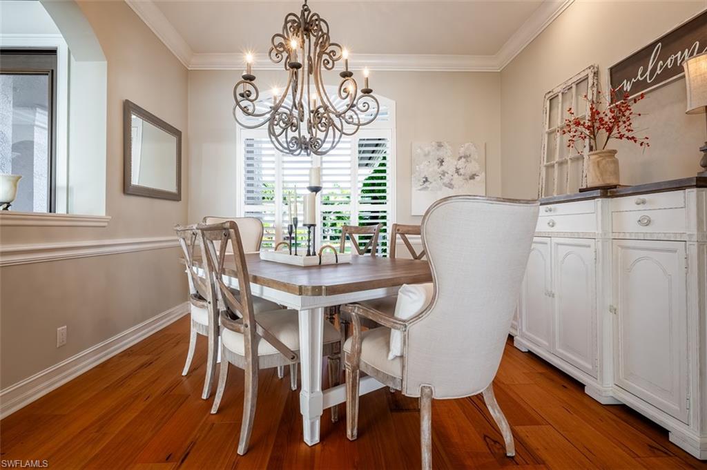 1942 Kingfish Road Naples, FL 34102 - Photo 20 of 43 a view of a dining room with furniture window and wooden floor