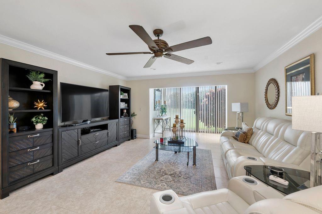 21452 Juego Circle, Unit 31A Boca Raton, FL 33433 - Photo 12 of 38 a living room with furniture a flat screen tv and a large window