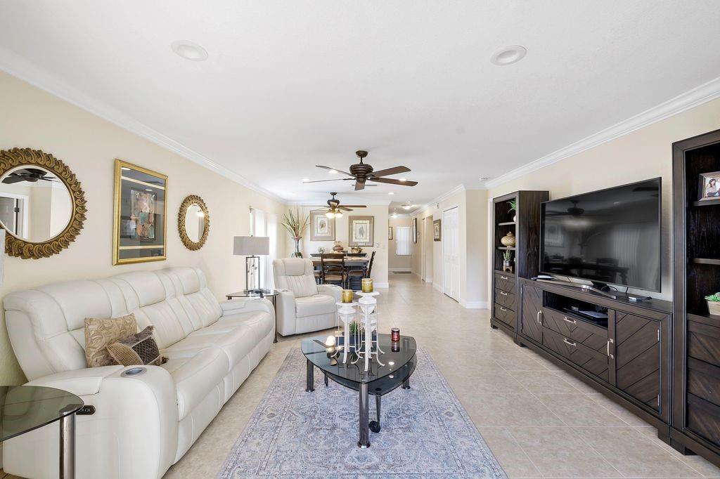 21452 Juego Circle, Unit 31A Boca Raton, FL 33433 - Photo 13 of 38 a living room with furniture and a flat screen tv
