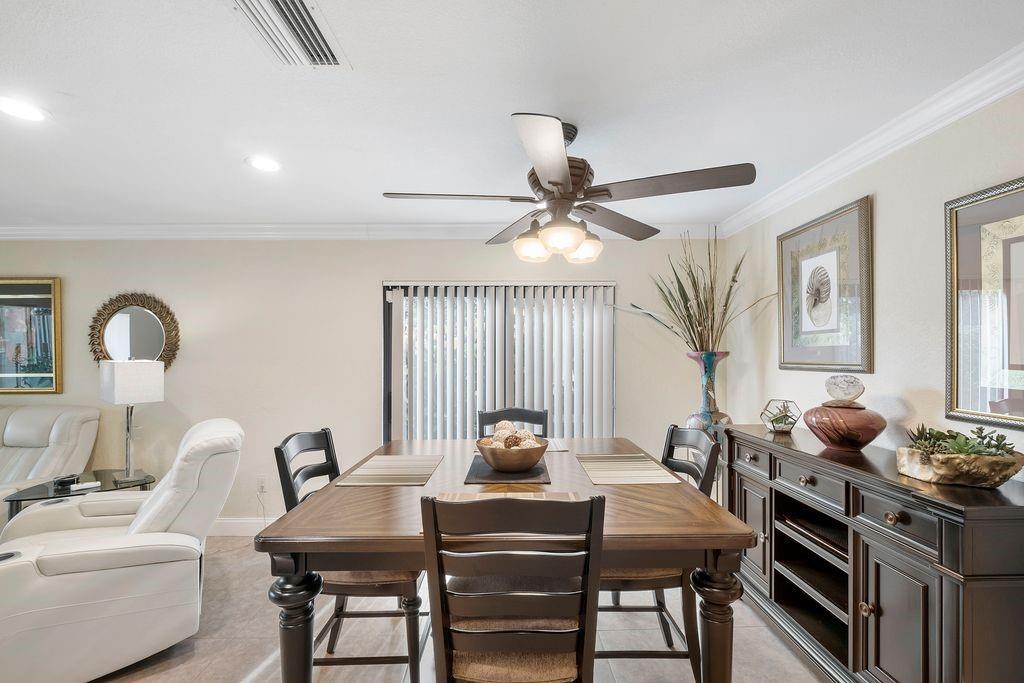 21452 Juego Circle, Unit 31A Boca Raton, FL 33433 - Photo 14 of 38 a view of a dining room with furniture and window