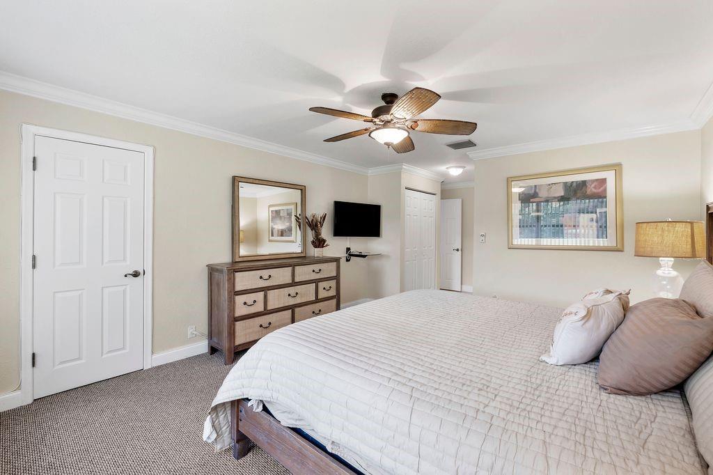 21452 Juego Circle, Unit 31A Boca Raton, FL 33433 - Photo 20 of 38 a bedroom with a large bed and a tv