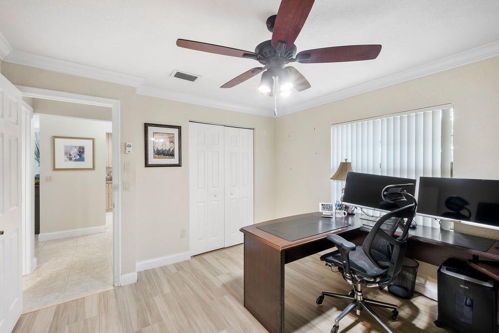 21452 Juego Circle, Unit 31A Boca Raton, FL 33433 - Photo 26 of 38 a workspace with wooden floor