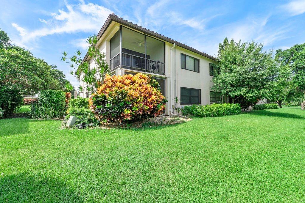 21452 Juego Circle, Unit 31A Boca Raton, FL 33433 - Photo 30 of 38 a front view of house with yard