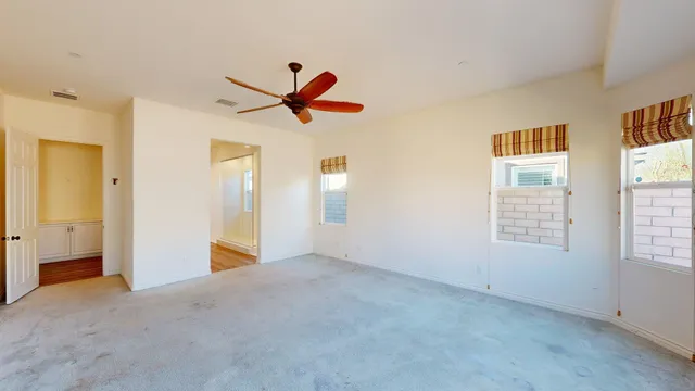 a view of a livingroom with a ceiling fan and window