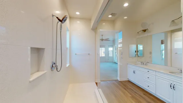 a bathroom with a glass shower door a sink and a shower
