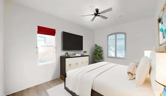 a bedroom with a bed and a flat screen tv