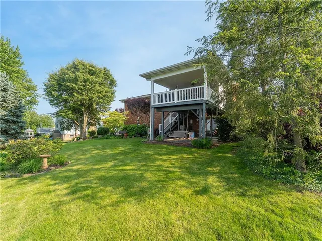 a view of a house with a yard porch and sitting area