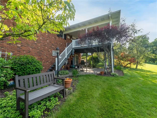 a view of a chair and table in the garden