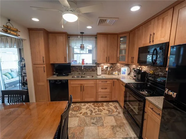 a kitchen with stainless steel appliances granite countertop a stove sink microwave and cabinets