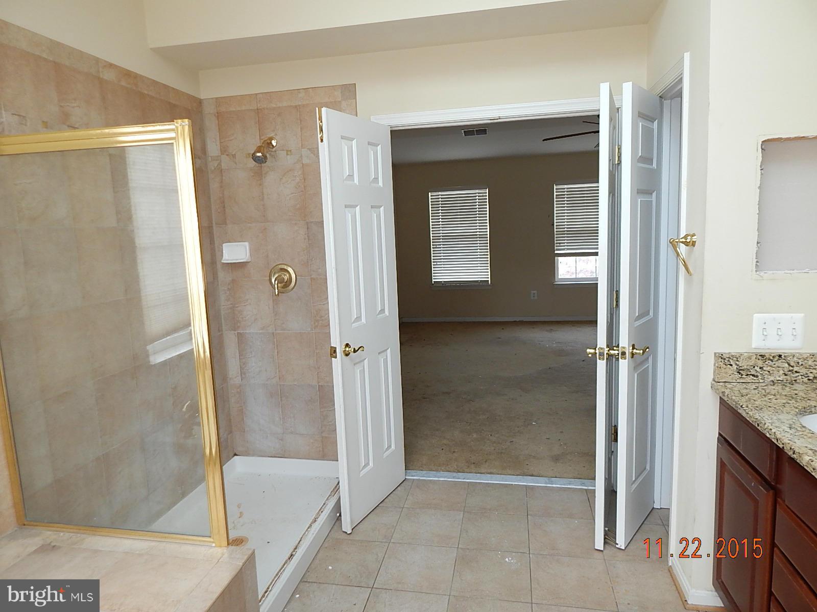 14411 Autumn Rust Road Boyds, MD 20841 - Photo 18 of 30 a bathroom with a granite countertop shower mirror and a sink