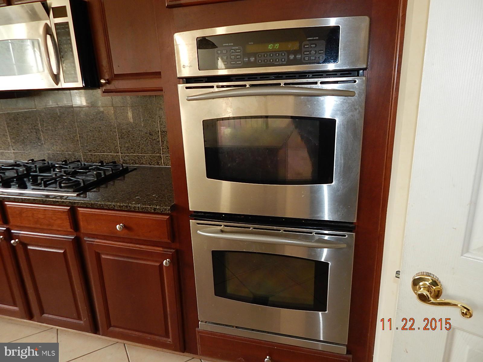 14411 Autumn Rust Road Boyds, MD 20841 - Photo 8 of 30 a stove top oven sitting inside of a kitchen