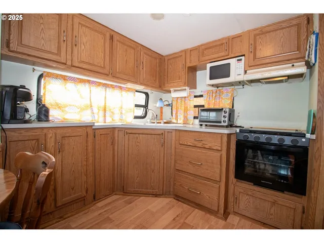 a kitchen with stainless steel appliances granite countertop a refrigerator sink and cabinets