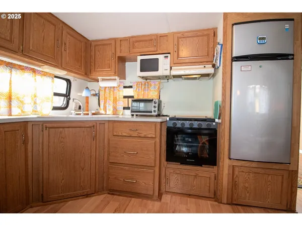 a kitchen with stainless steel appliances a refrigerator and cabinets
