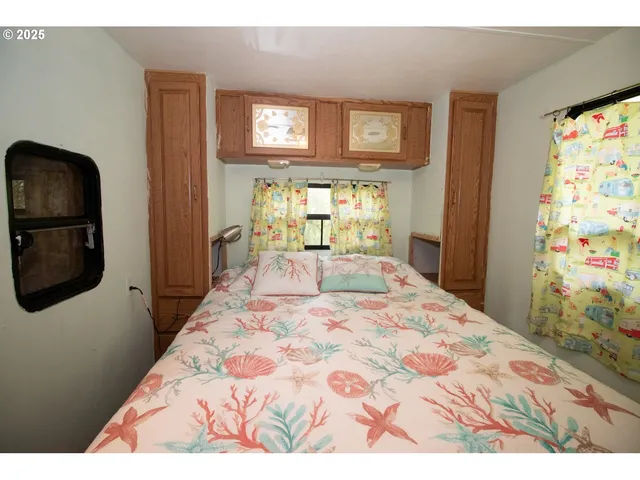 a bedroom with a bed and a flat screen tv in a dresser