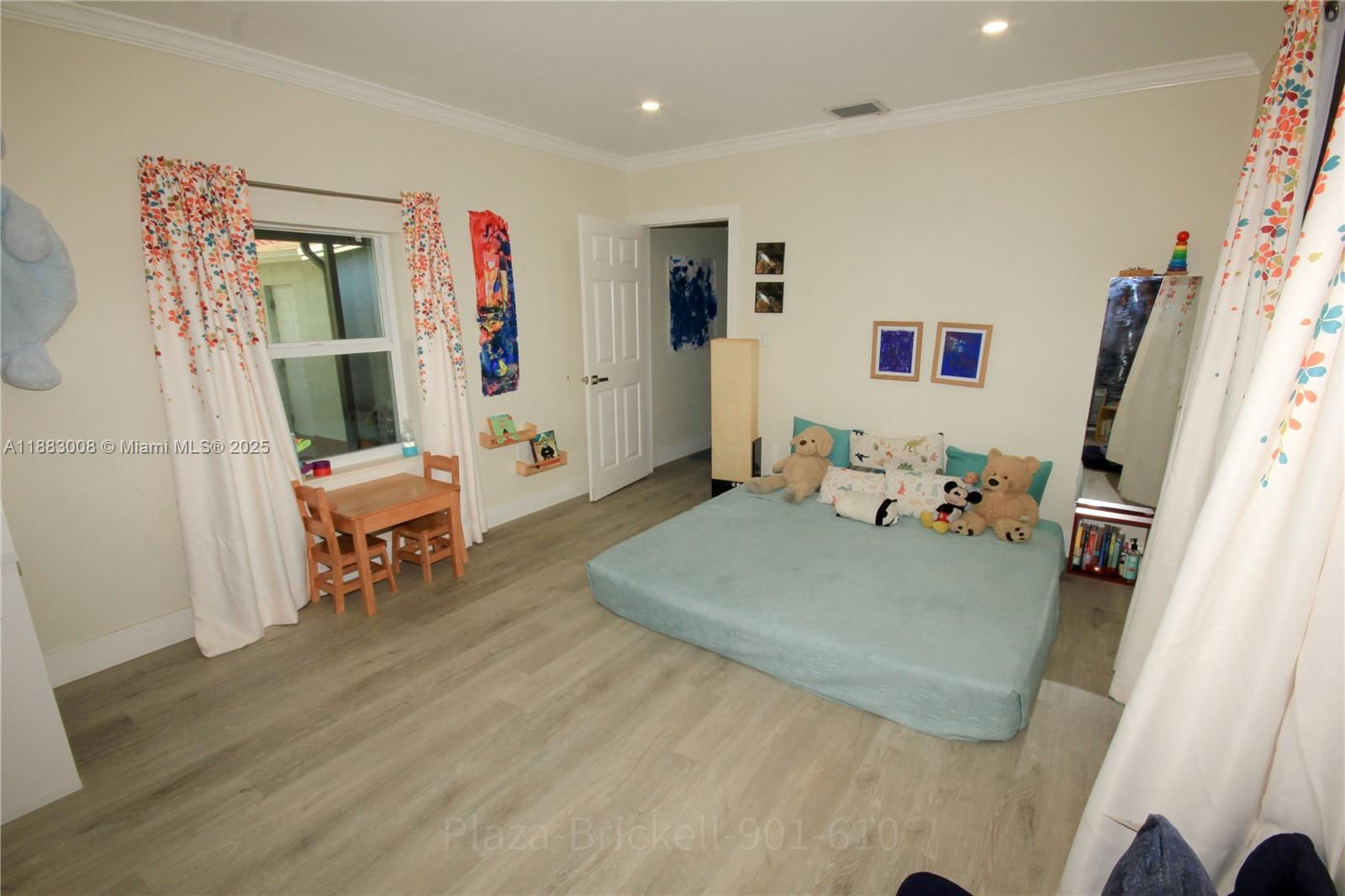 2754 Southwest 36th Avenue Miami, FL 33133 - Photo 14 of 35 This versatile indoor area features an open layout with natural light, built-in shelves for storage, and a door leading to another space, making it suitable for a bedroom, playroom, or study.