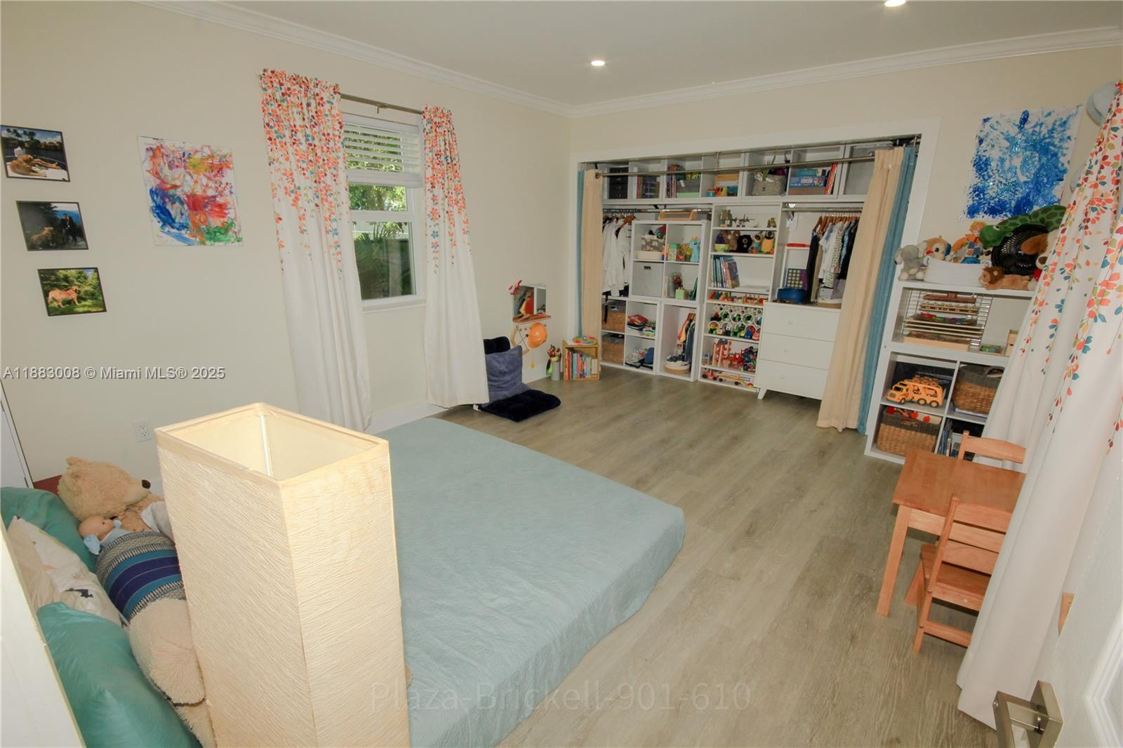 2754 Southwest 36th Avenue Miami, FL 33133 - Photo 15 of 35 This spacious indoor area provides flexibility for various uses, such as a bedroom or playroom, with a layout that promotes easy movement and includes designated storage for organization.