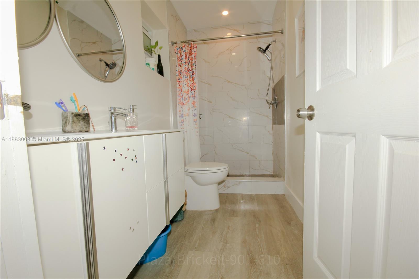 2754 Southwest 36th Avenue Miami, FL 33133 - Photo 20 of 35 This bathroom features a practical layout with an accessible shower area and essential fixtures, providing a functional space for daily routines and accommodating both residents and guests comfortably.