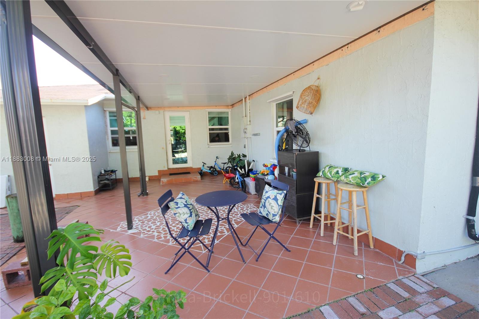 2754 Southwest 36th Avenue Miami, FL 33133 - Photo 23 of 35 This versatile indoor area is perfect for relaxation or entertaining, featuring an open layout with large windows for natural light and a covered section for year-round enjoyment.