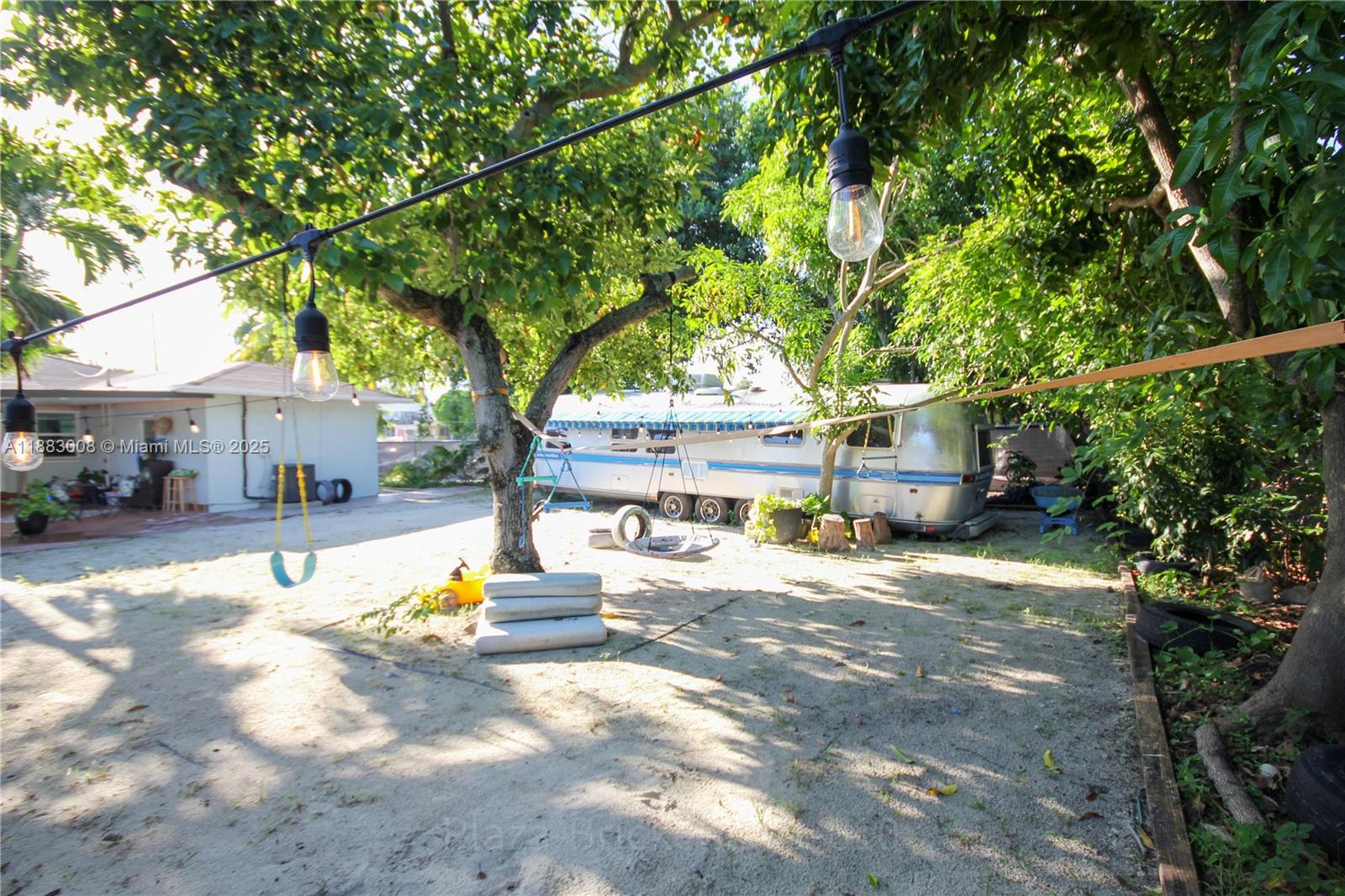 2754 Southwest 36th Avenue Miami, FL 33133 - Photo 27 of 35 This outdoor area provides a versatile space for gatherings and activities, enhanced by mature trees for shade and a well-maintained surface, inviting personal touches and future pool possibilities.
