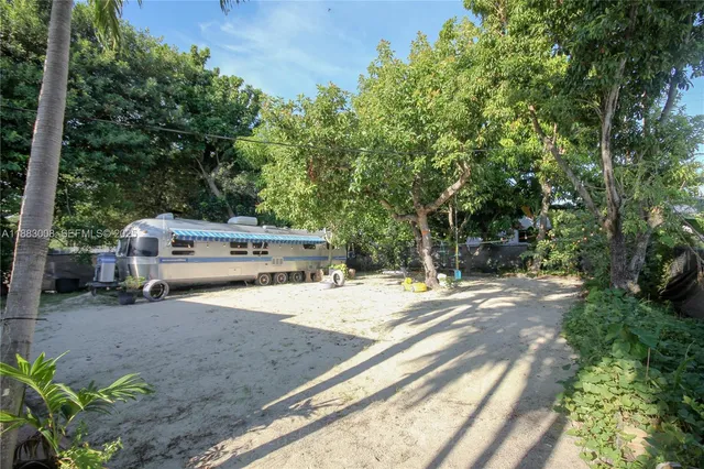 a backyard of a house with a tree