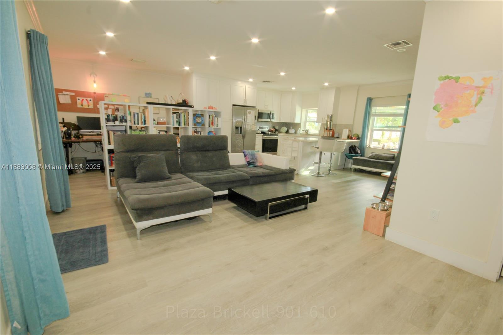 2754 Southwest 36th Avenue Miami, FL 33133 - Photo 4 of 35 This indoor area features an open layout that encourages interaction and flexibility, with a well-placed kitchen for entertaining and easy access to outdoor space for various activities.