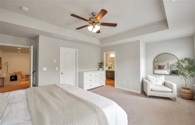 a spacious bedroom with a bed and a chandelier