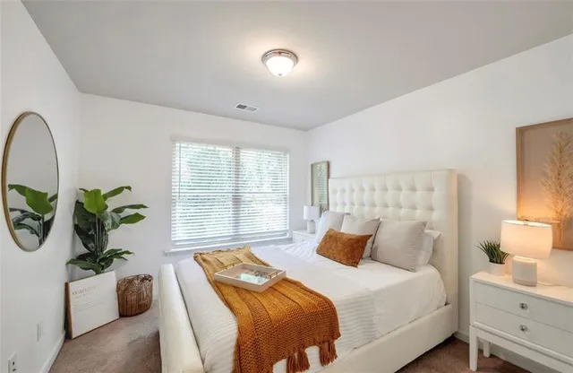 a bedroom with bed and a window