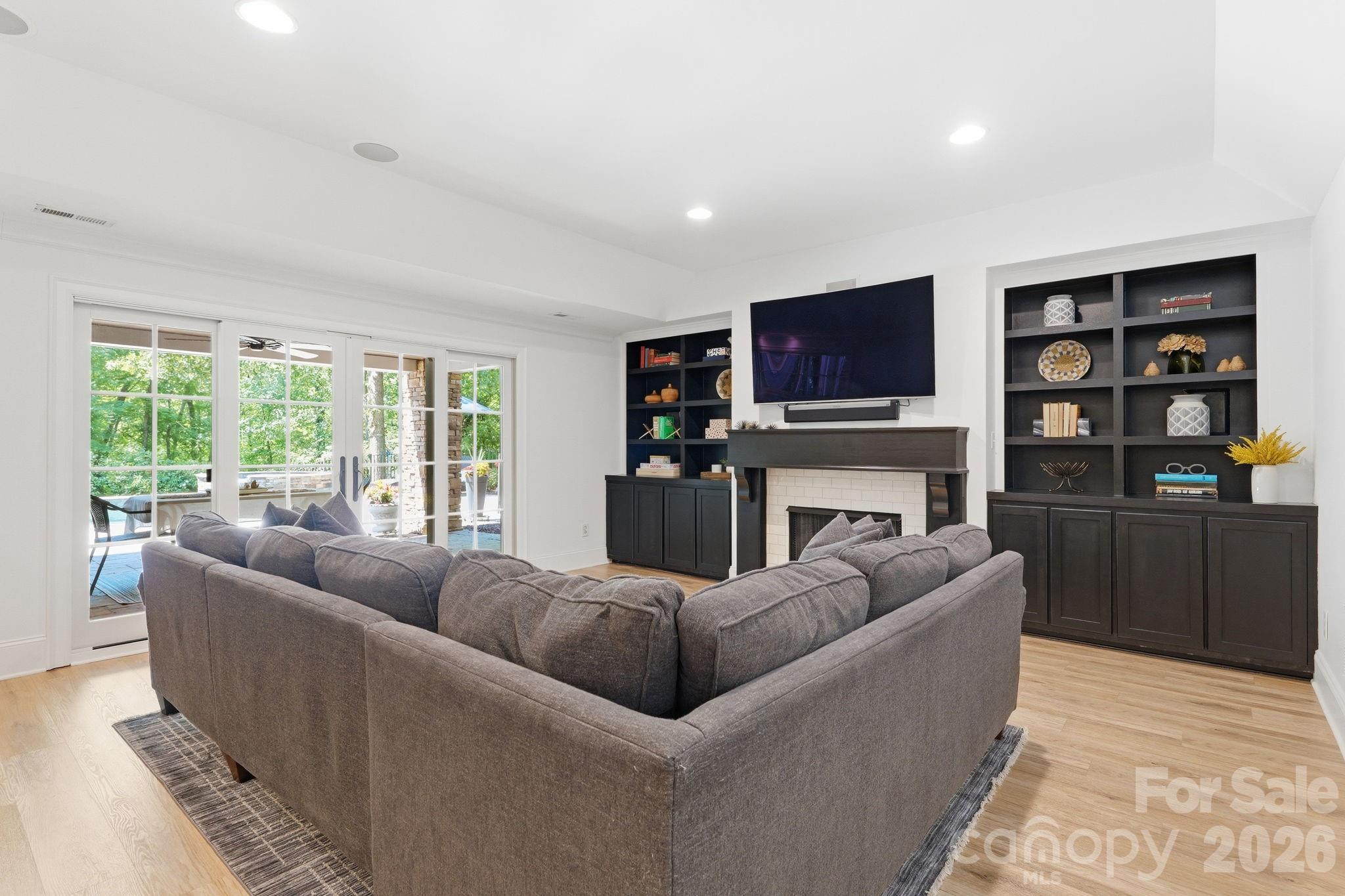 235 Grey Road Davidson, NC 28036 - Photo 31 of 42 a living room with fireplace furniture and a flat screen tv