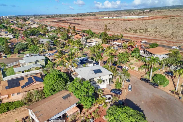 an aerial view of a house with a yard and garden