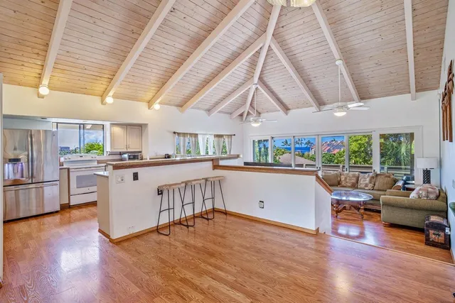 a kitchen with a sink cabinets and wooden floor