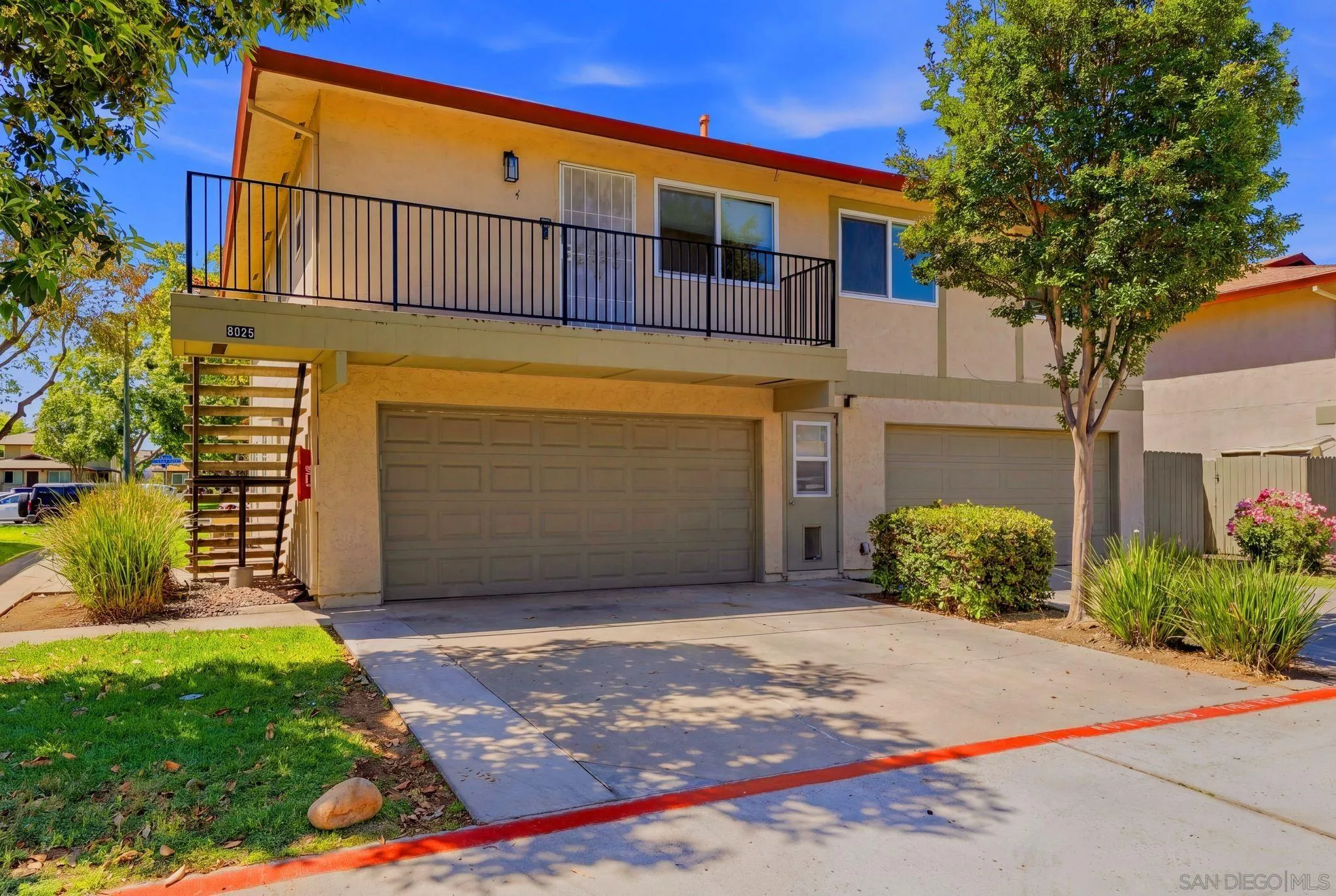 9926 Mission Vega Road, Unit 4 Santee, CA 92071 - Photo 26 of 30 a front view of a house with a yard and garage