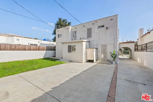a view of a white house with a yard and a garage