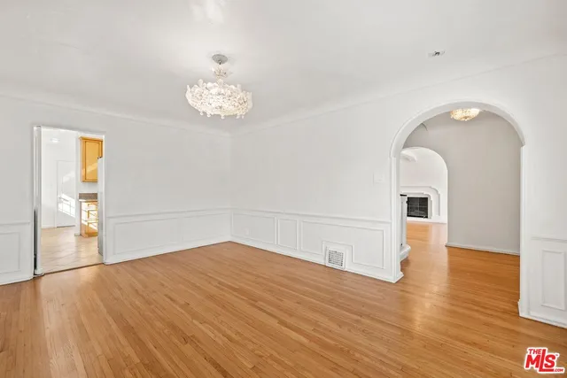 a view of a room with wooden floor and chandelier