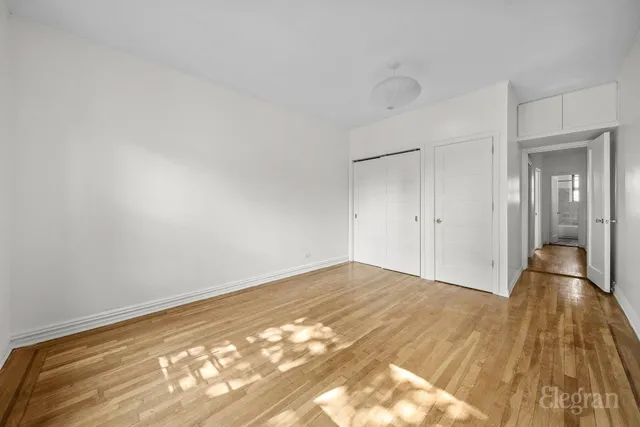 wooden floor in a room next to a window