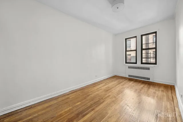 a bedroom with bed and a potted plant