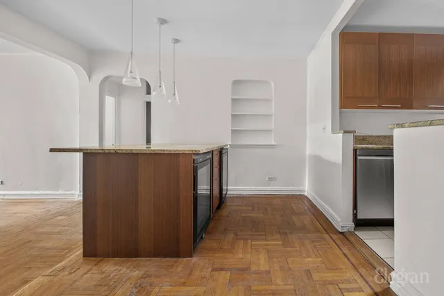 a view of an empty room with a cabinet