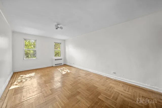 a view of a kitchen with a sink and cabinets