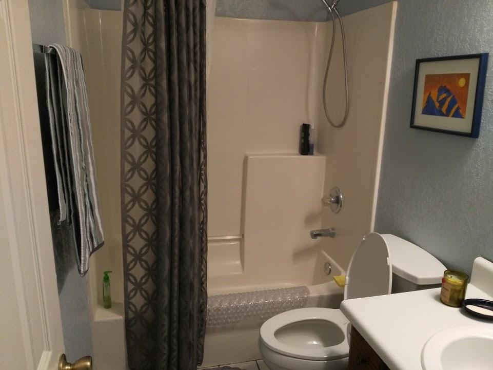 707 Valley Road Crestview, FL 32539 - Photo 13 of 14 a bathroom with a toilet and a shower curtain