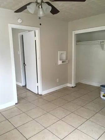 a view of a room with wooden floor and cabinet