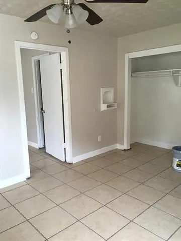 a view of a room with wooden floor and cabinet