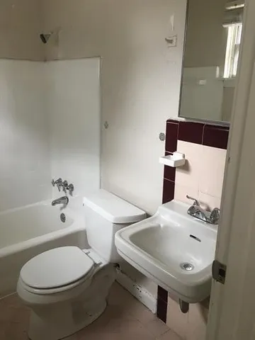 a bathroom with a toilet a sink and bathtub