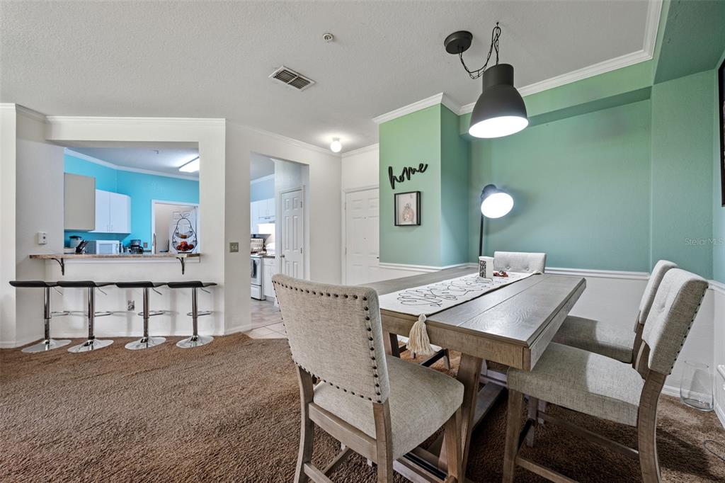3701 Conroy Road, Unit 1812 Orlando, FL 32839 - Photo 11 of 37 a view of a dining room and a table and chairs in a room