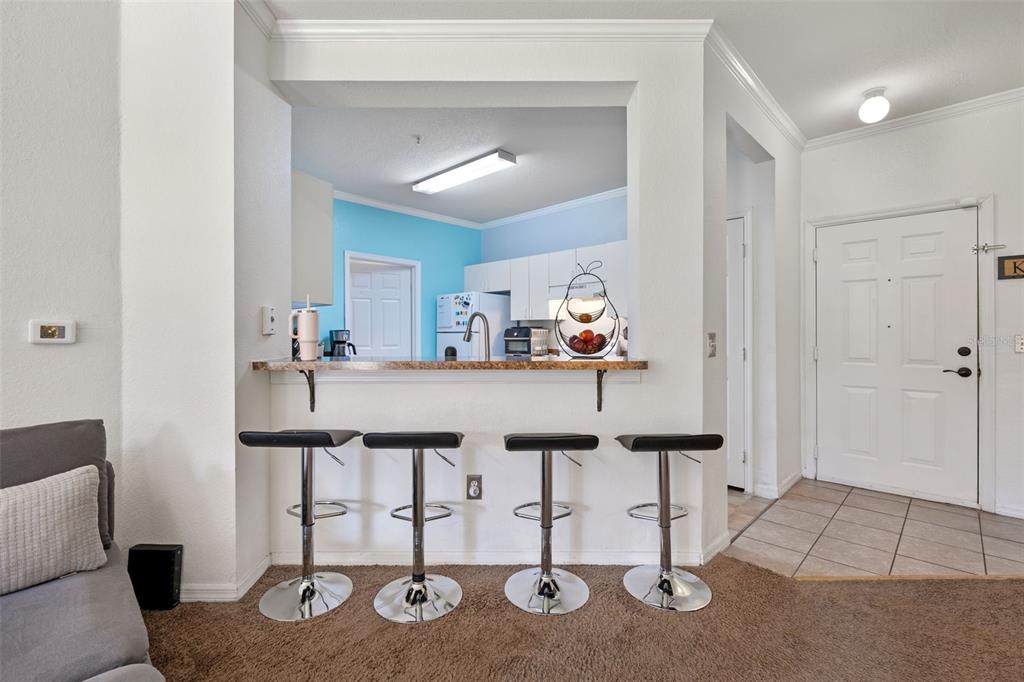 3701 Conroy Road, Unit 1812 Orlando, FL 32839 - Photo 12 of 37 a view of kitchen island with furniture and appliances
