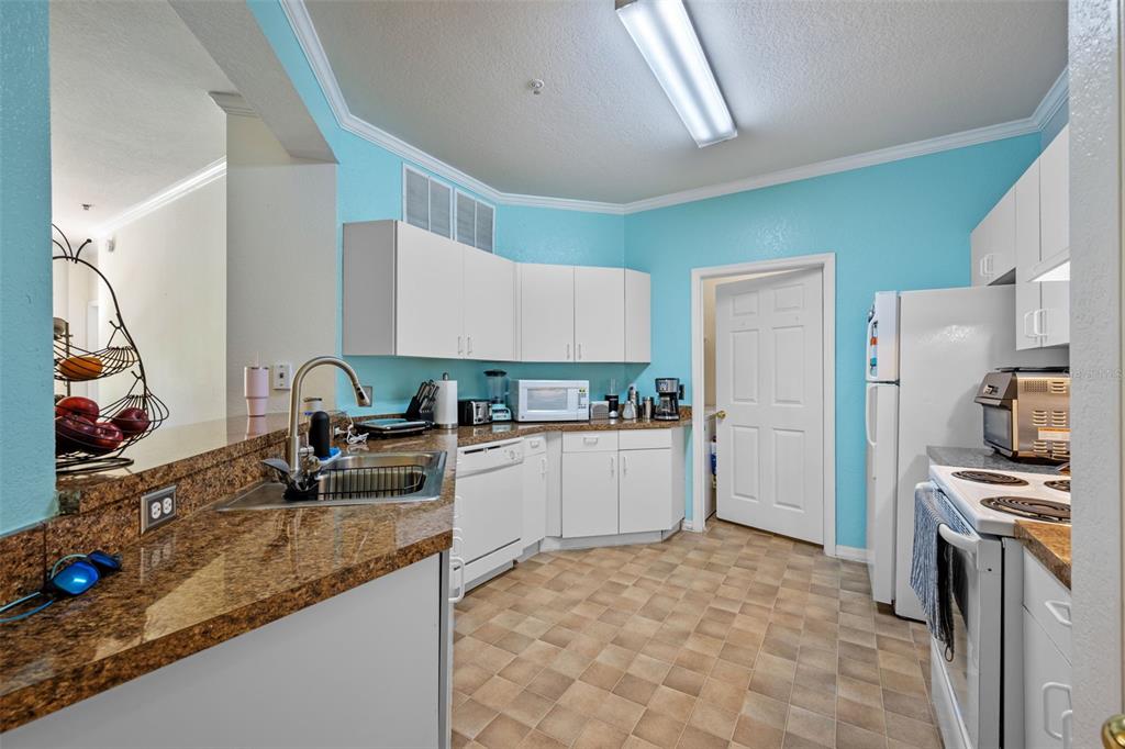 3701 Conroy Road, Unit 1812 Orlando, FL 32839 - Photo 14 of 37 a kitchen with a sink appliances and cabinets