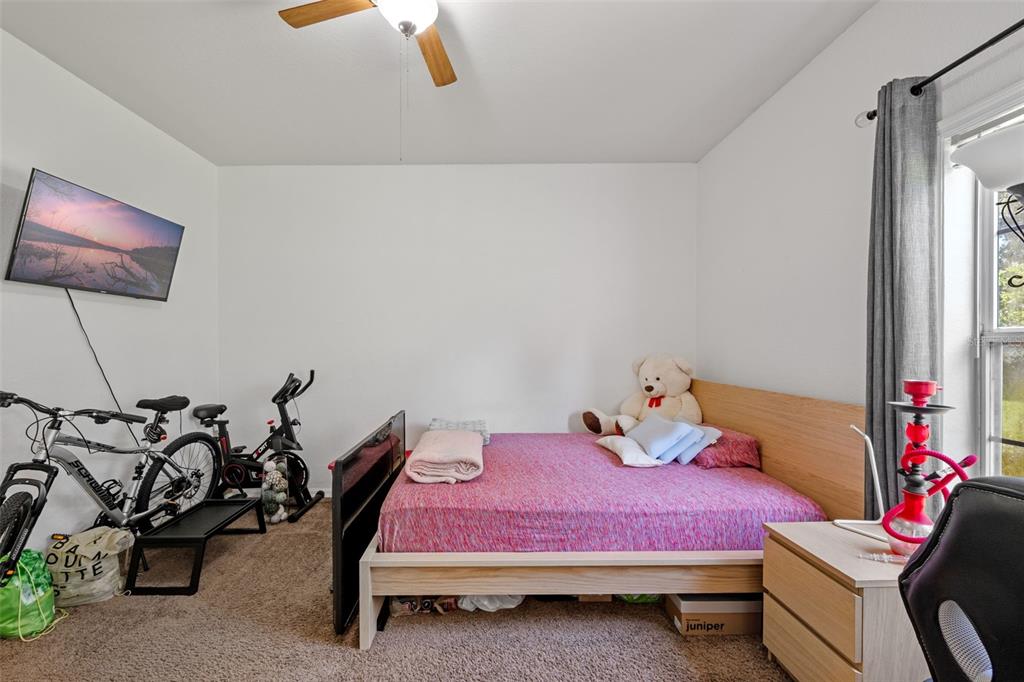 3701 Conroy Road, Unit 1812 Orlando, FL 32839 - Photo 19 of 37 a bedroom with a bed and a chandelier