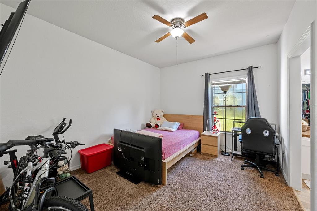 3701 Conroy Road, Unit 1812 Orlando, FL 32839 - Photo 20 of 37 a bedroom with a bed and a window