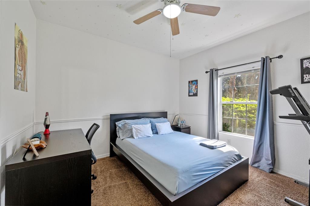 3701 Conroy Road, Unit 1812 Orlando, FL 32839 - Photo 21 of 37 a bedroom with a bed and a chandelier